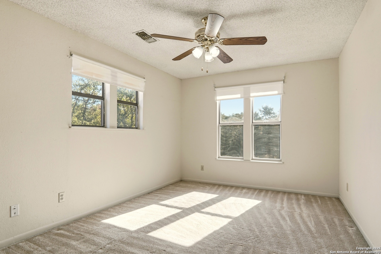 261 Fawn Lane Spring Branch, TX 78070 - Photo 16 of 36 a view of an empty room with a window and a chandelier fan