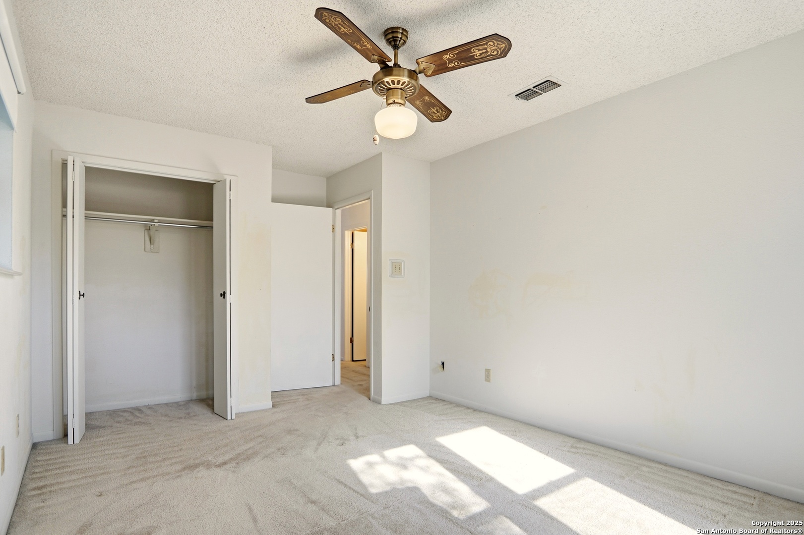 261 Fawn Lane Spring Branch, TX 78070 - Photo 18 of 36 an empty room with windows and fan