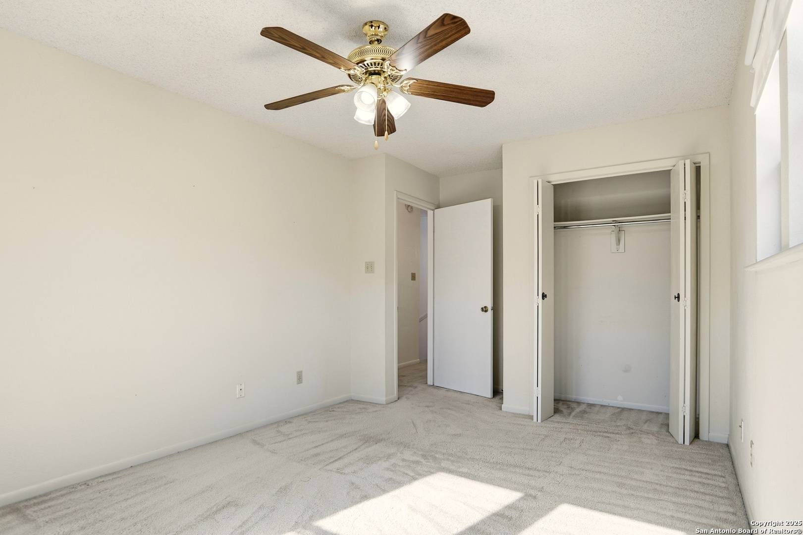 261 Fawn Lane Spring Branch, TX 78070 - Photo 19 of 36 an empty room with closet and a ceiling fan