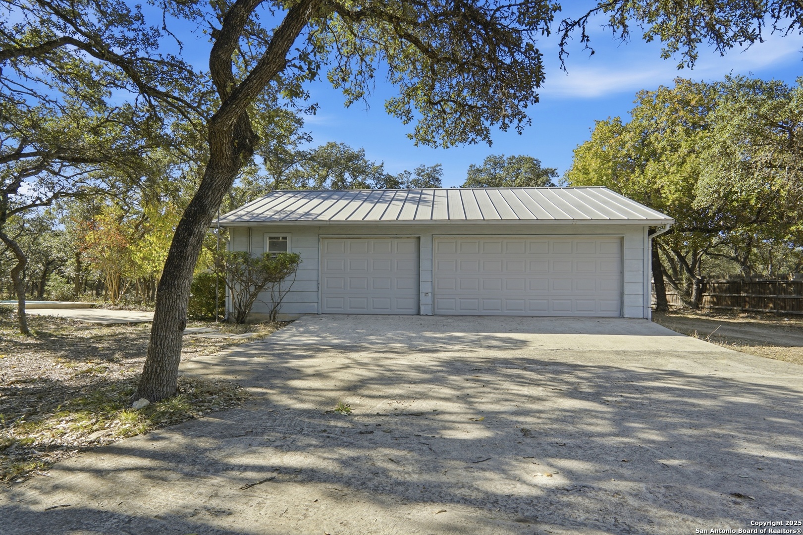 261 Fawn Lane Spring Branch, TX 78070 - Photo 25 of 36 a front view of a house with a yard and garage