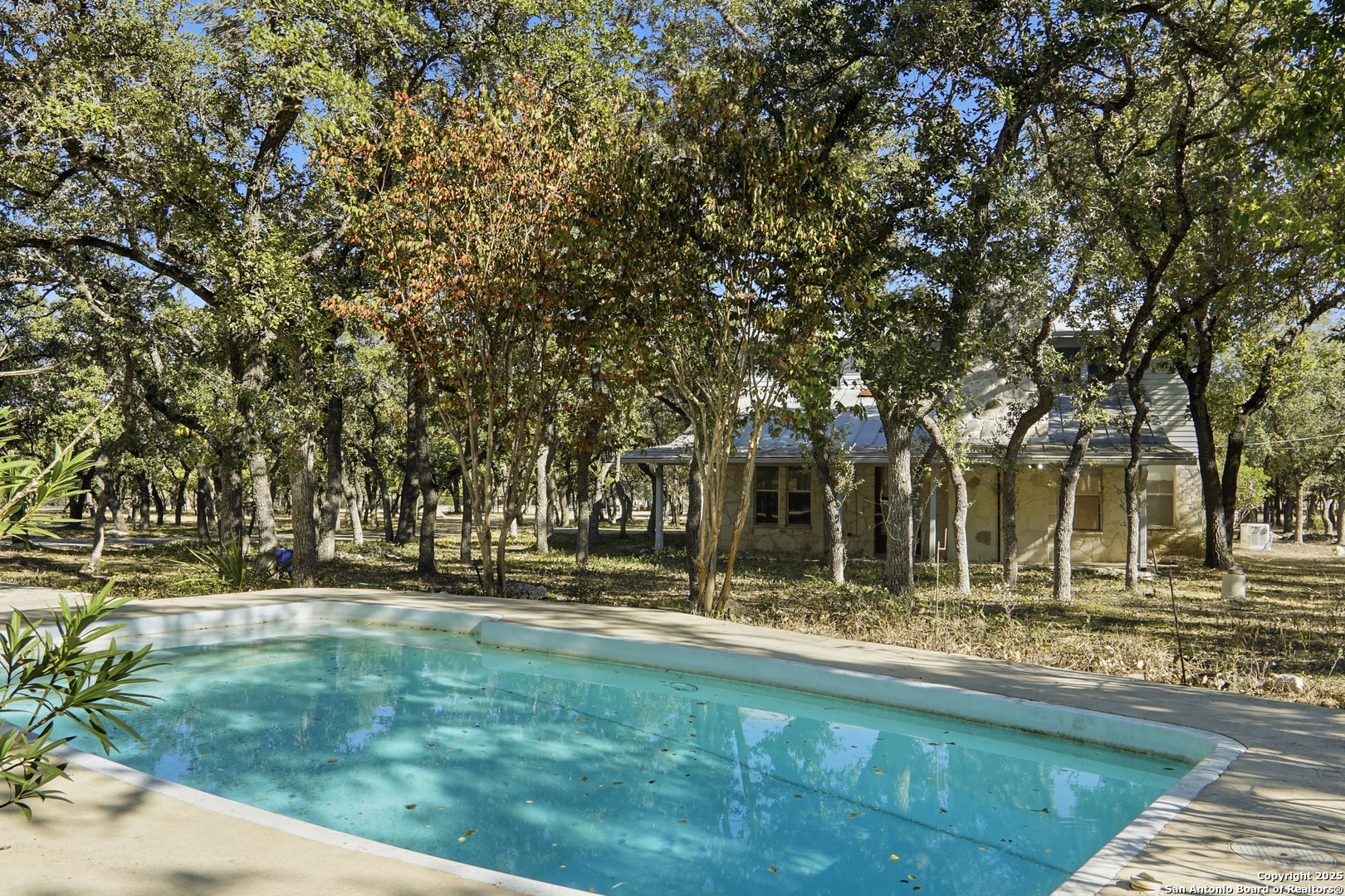 261 Fawn Lane Spring Branch, TX 78070 - Photo 26 of 36 a view of swimming pool with outdoor seating and trees