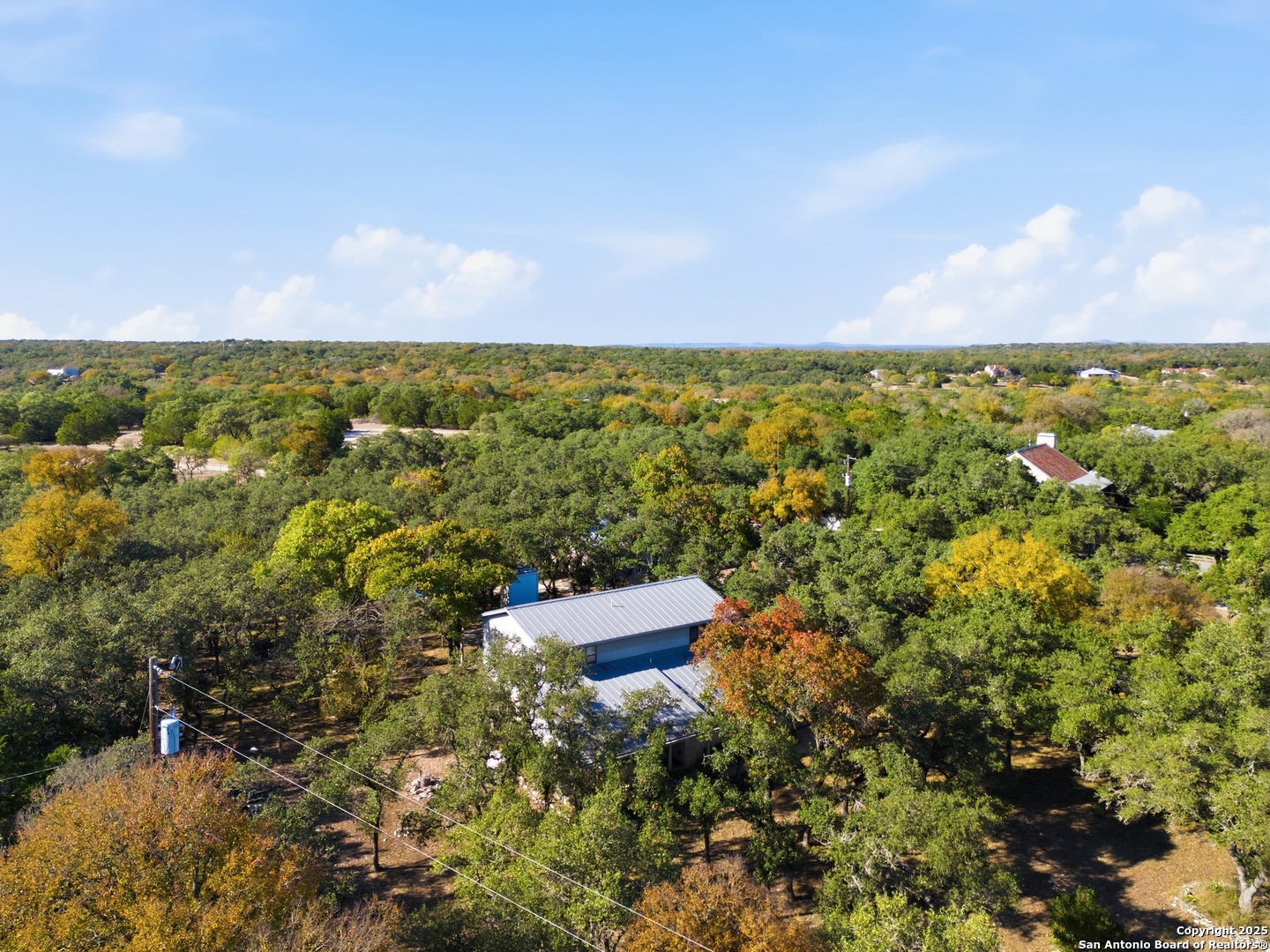 261 Fawn Lane Spring Branch, TX 78070 - Photo 32 of 36 an aerial view of a city with lots of residential buildings and mountain view in back