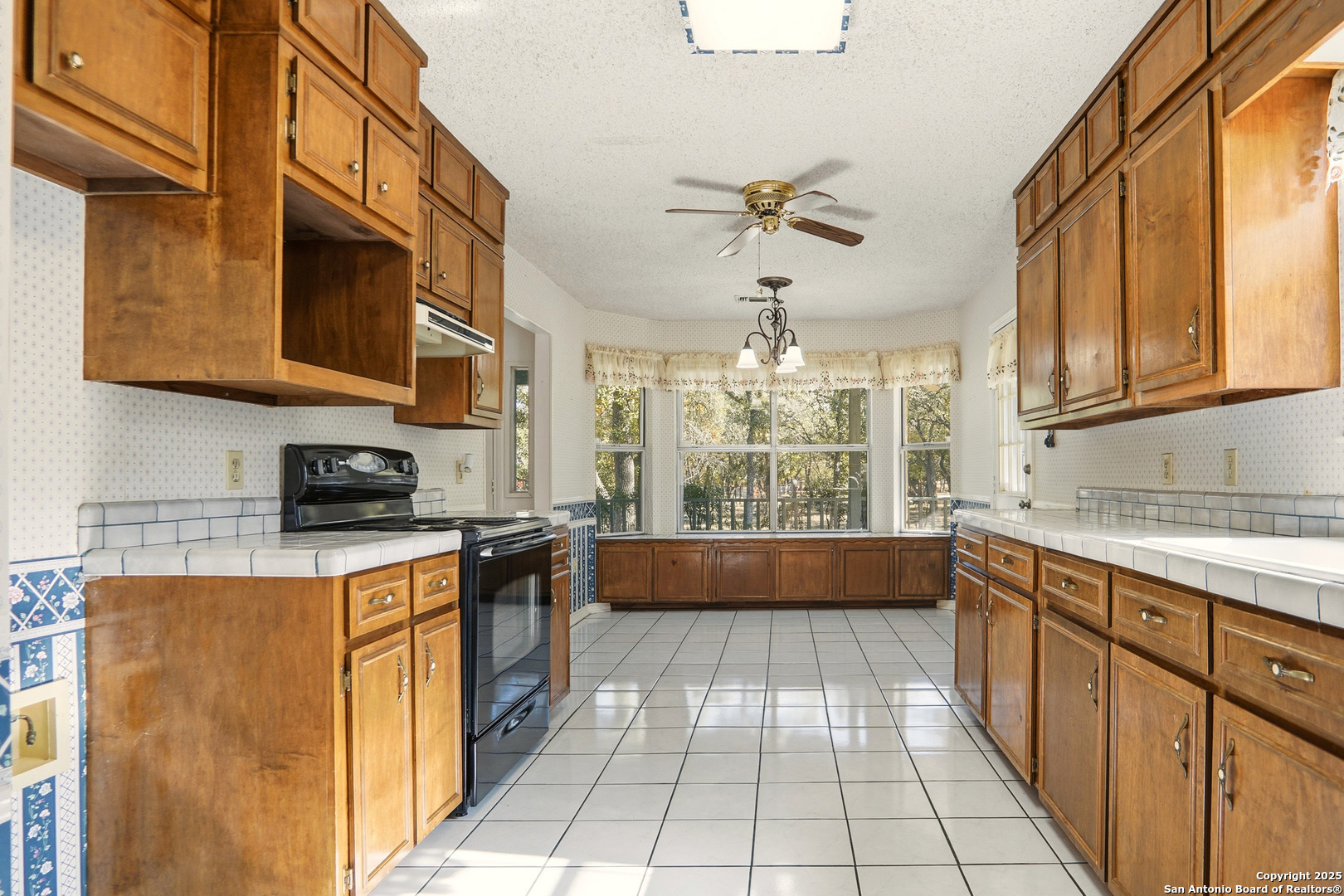 261 Fawn Lane Spring Branch, TX 78070 - Photo 5 of 36 a kitchen with stainless steel appliances granite countertop a stove a sink and a microwave