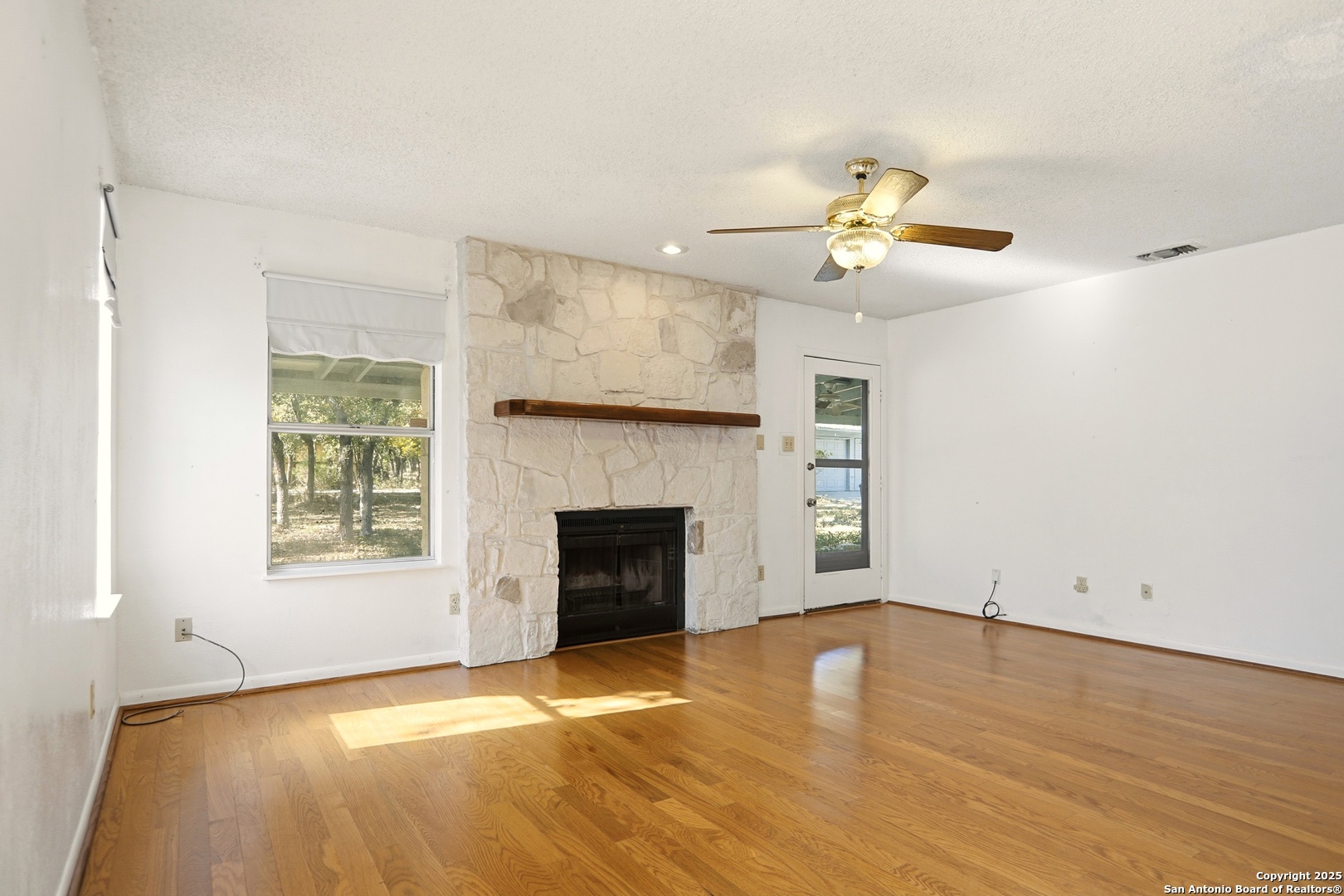 261 Fawn Lane Spring Branch, TX 78070 - Photo 8 of 36 a view of an empty room with a fireplace and a window