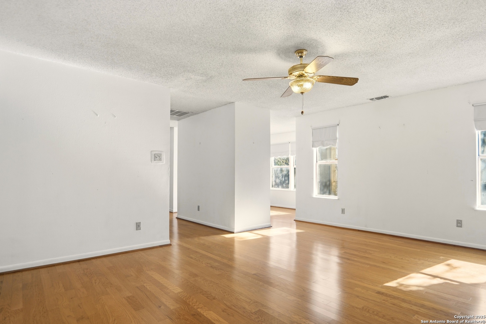 261 Fawn Lane Spring Branch, TX 78070 - Photo 9 of 36 a view of an empty room with window and wooden floor