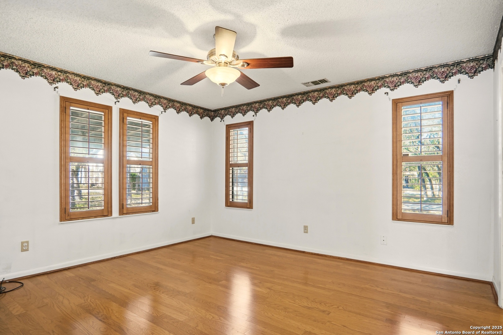 261 Fawn Lane Spring Branch, TX 78070 - Photo 10 of 36 a view of an empty room with a window and wooden floor