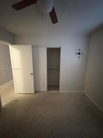 an empty room with wooden door and mirror