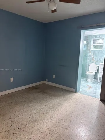 a view of a yard with plants and a tree