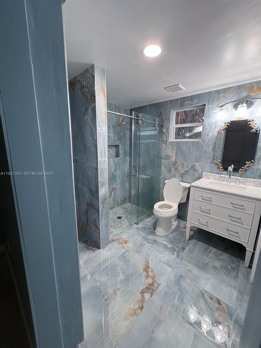 3821 Northwest 208th Street Miami Gardens, FL 33055 - Photo 19 of 23 a bathroom with a sink toilet and shower