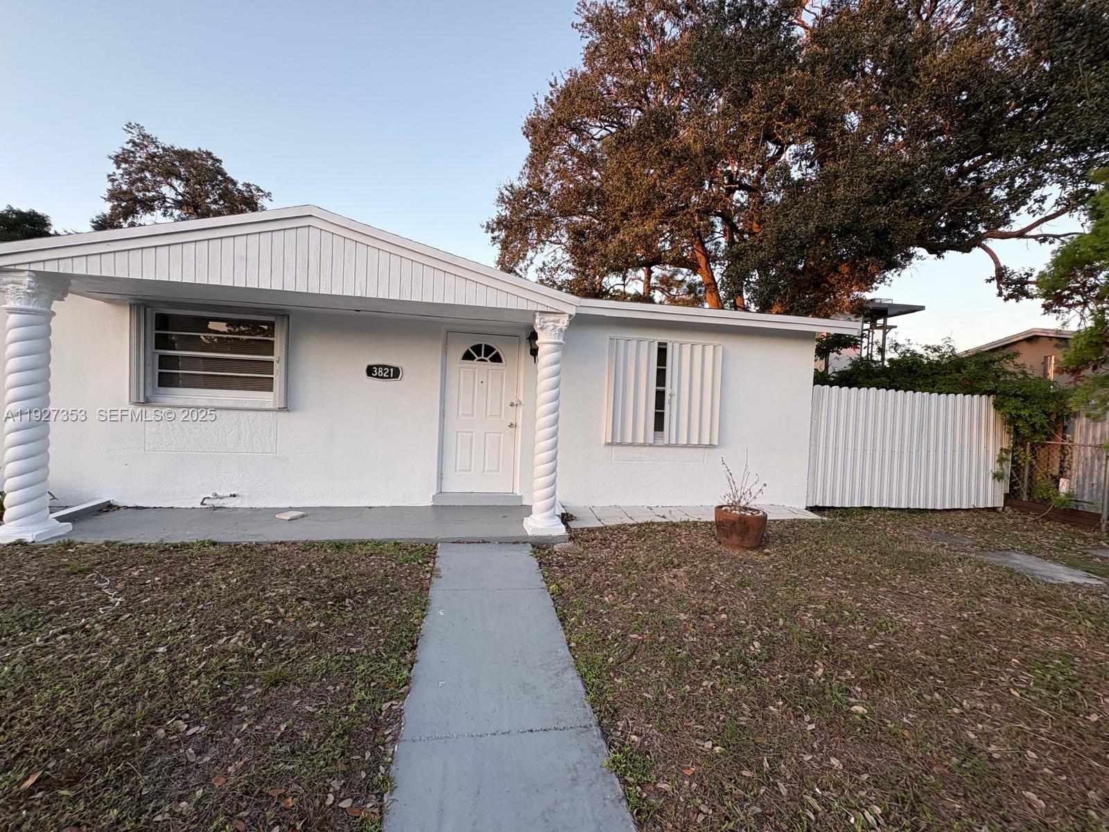 3821 Northwest 208th Street Miami Gardens, FL 33055 - Photo 3 of 23 a front view of a house with a yard