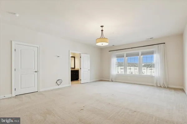 an empty room with a empty space and windows