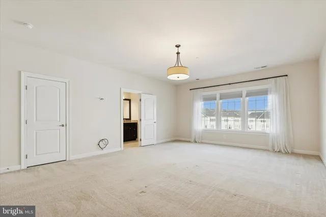 an empty room with a empty space and windows