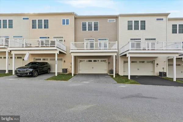 a couple of cars parked in front of a building