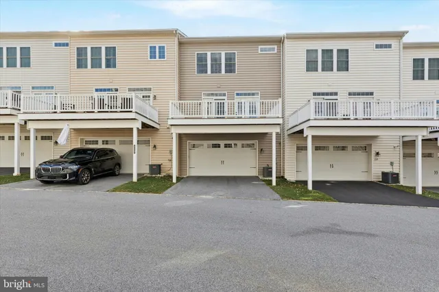 a couple of cars parked in front of a building