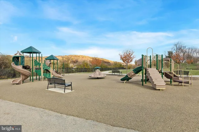 a view of a park with swings and slides