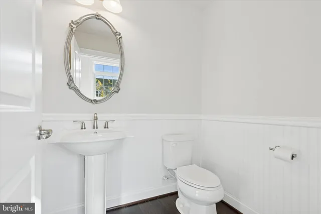 a bathroom with a toilet sink and mirror