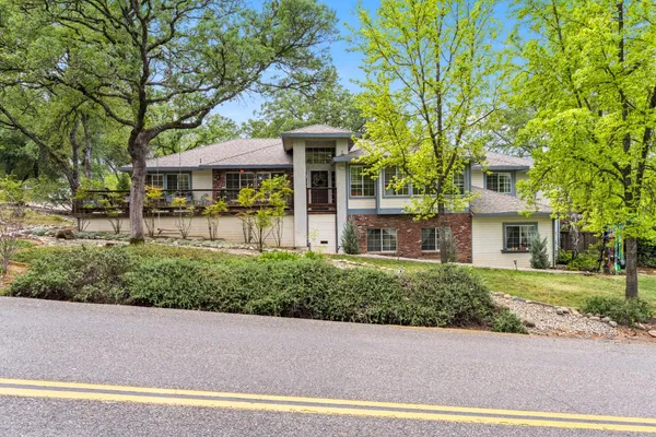a view of a balcony with chairs and wooden floor