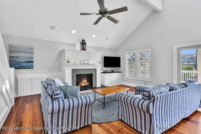 a living room with furniture fireplace and flat screen tv