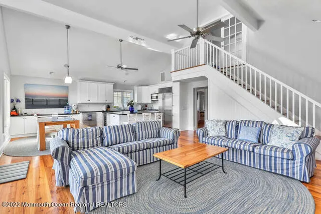 a living room with furniture ceiling fan and a rug