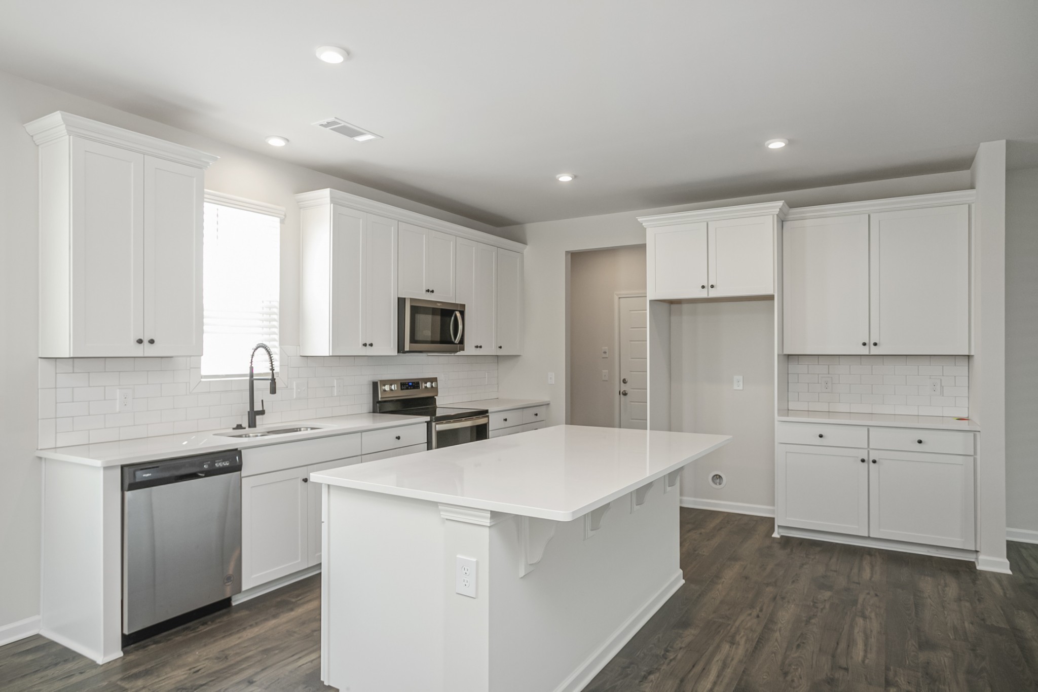 2525 Pleasant Ridge Run Mount Juliet, TN 37122 - Photo 5 of 27 a kitchen with white cabinets and stainless steel appliances