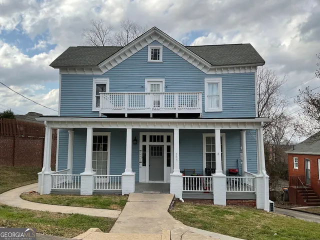 a front view of a house with a yard and porch