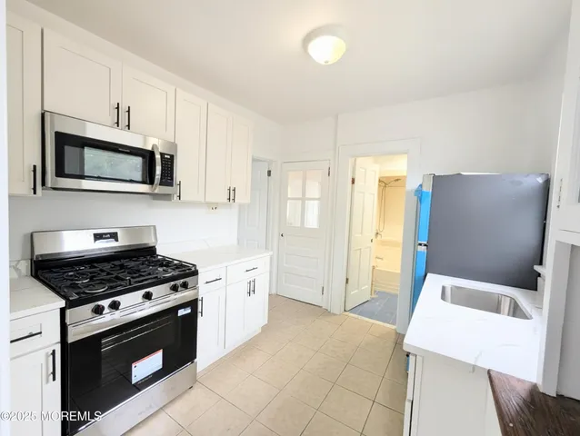a kitchen with cabinets and steel stainless steel appliances