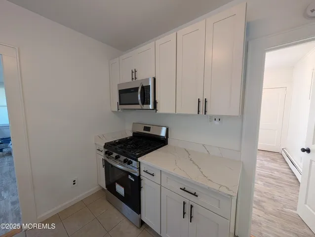 a view of a kitchen with appliances