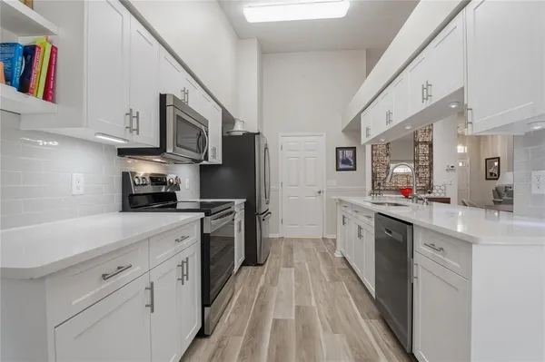 a bathroom with a granite countertop sink a large mirror and a shower