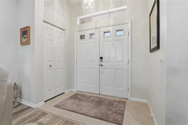 a dining room with furniture a chandelier and window