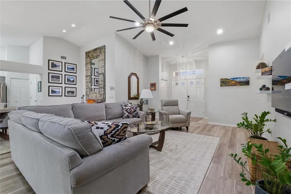a kitchen with stainless steel appliances a refrigerator a sink and white cabinets