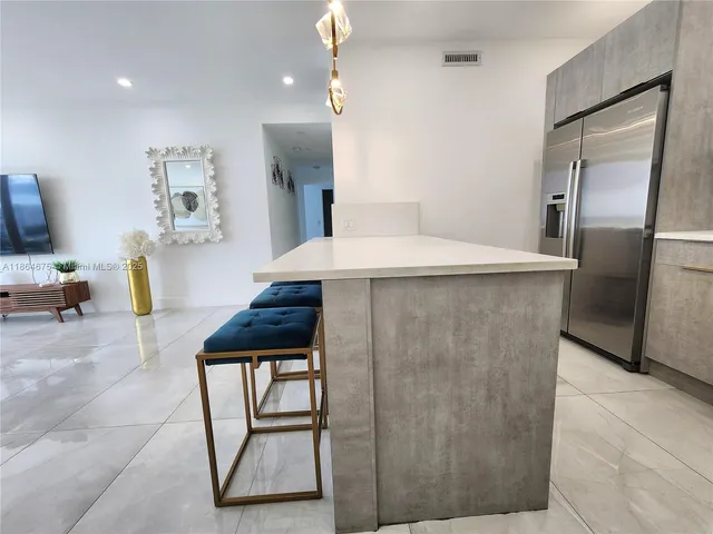 a spacious bedroom with a bed and a flat screen tv