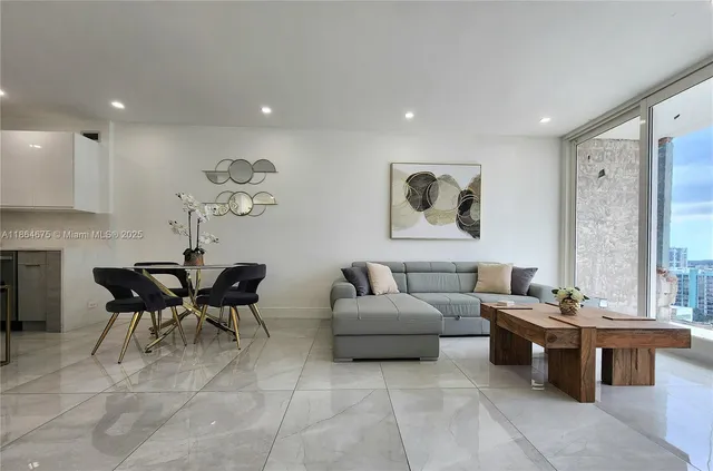 a kitchen with stainless steel appliances granite countertop a stove a sink a microwave a refrigerator and a cabinets