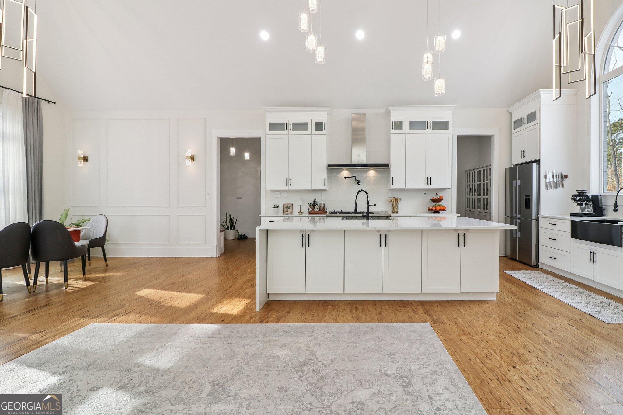 4032 Wesley Chapel Road Roswell, GA 30075 - Photo 15 of 36 a large kitchen with stainless steel appliances kitchen island granite countertop a sink and cabinets