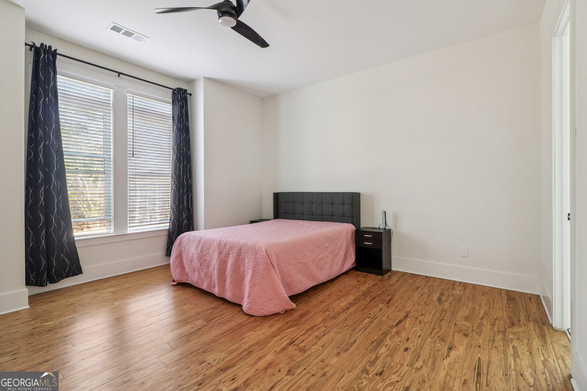 4032 Wesley Chapel Road Roswell, GA 30075 - Photo 20 of 36 a bedroom with a bed and wooden floor