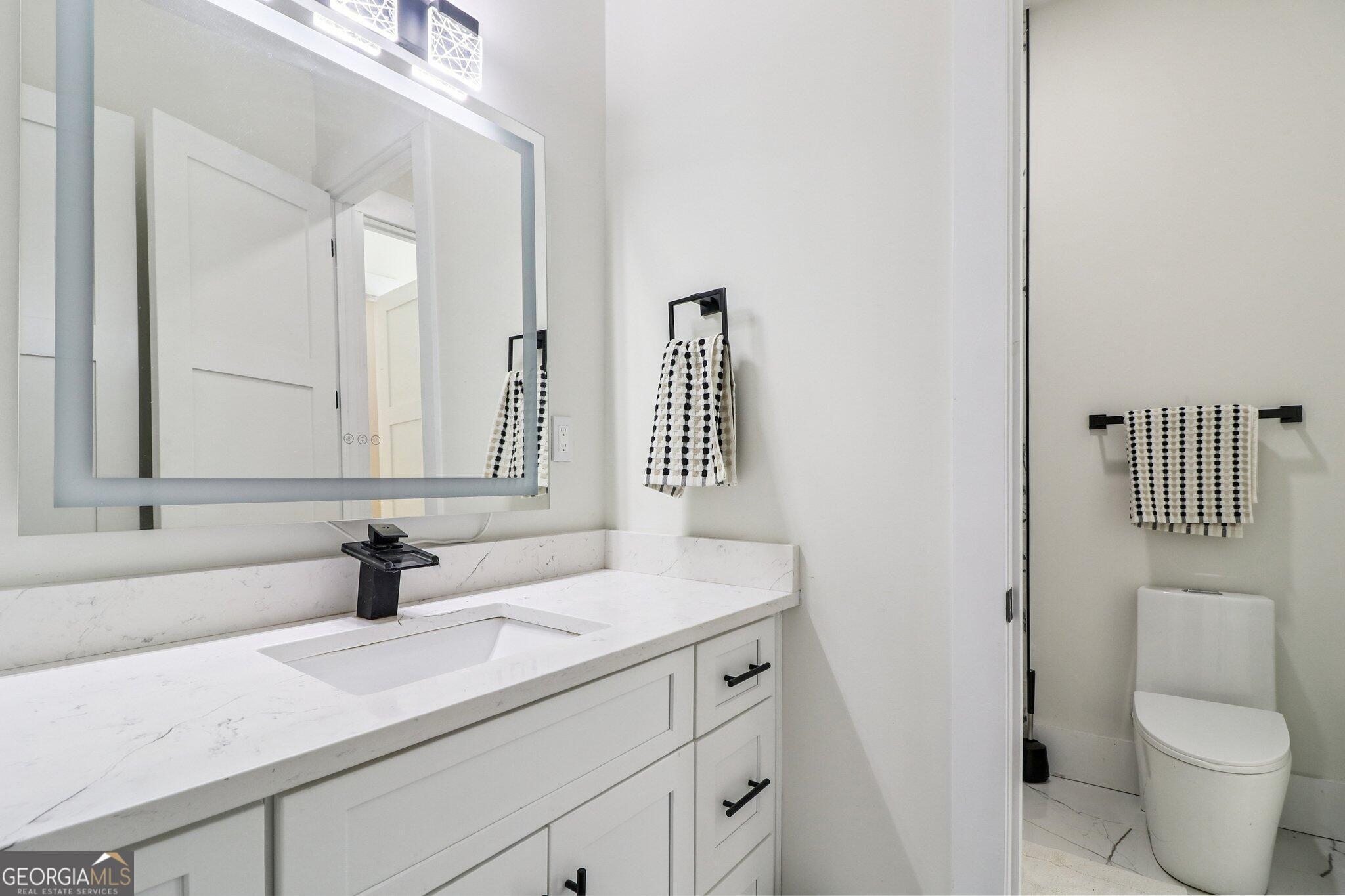 4032 Wesley Chapel Road Roswell, GA 30075 - Photo 22 of 36 a bathroom with a sink toilet and mirror