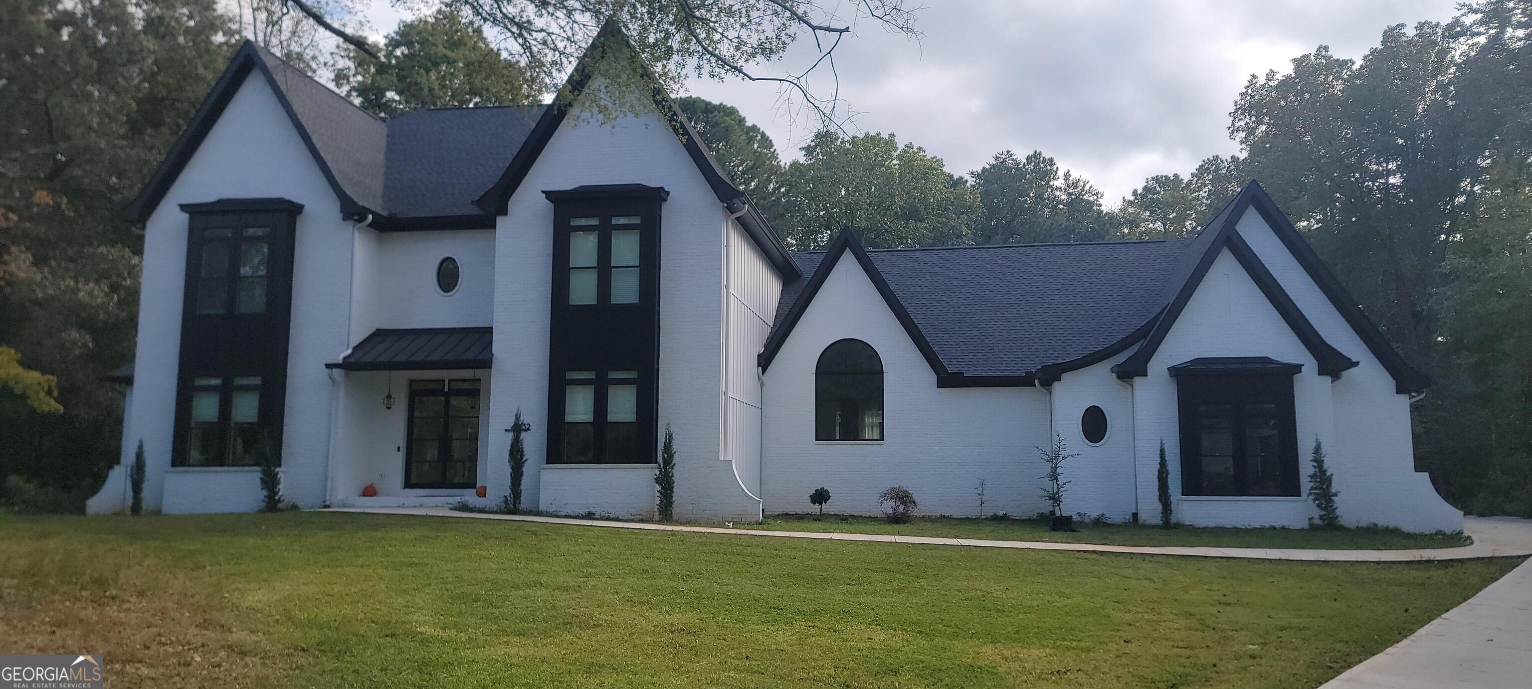 4032 Wesley Chapel Road Roswell, GA 30075 - Photo 4 of 36 a front view of a house with a yard