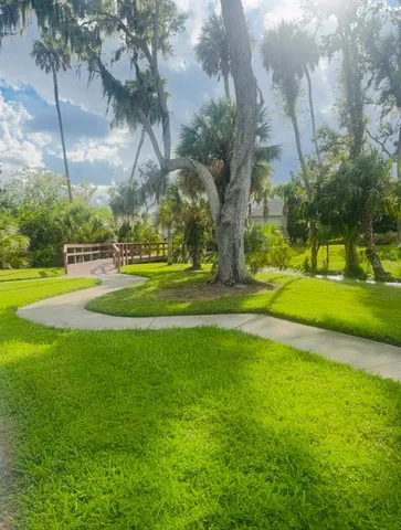 a house view with outdoor seating space and garden