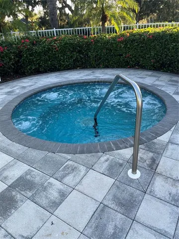 a view of a patio with table and chairs with wooden fence