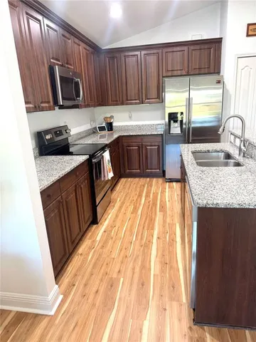 a view of a room with wooden floor and cabinet