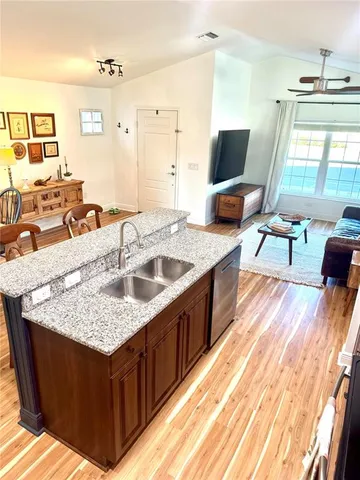 a dining room with furniture a chandelier and wooden floor