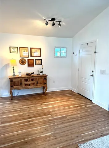 a kitchen with sink stove top oven and living room