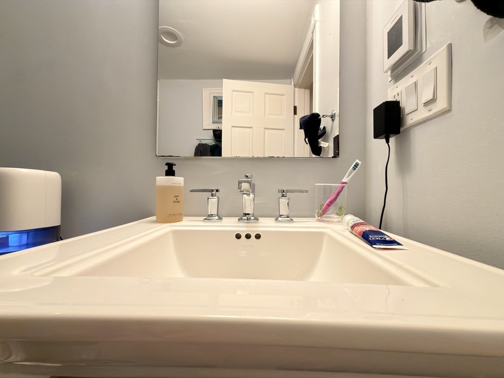 41 Pinckney Street, Unit B Boston, MA 02114 - Photo 13 of 31 a bathroom with a sink and a mirror