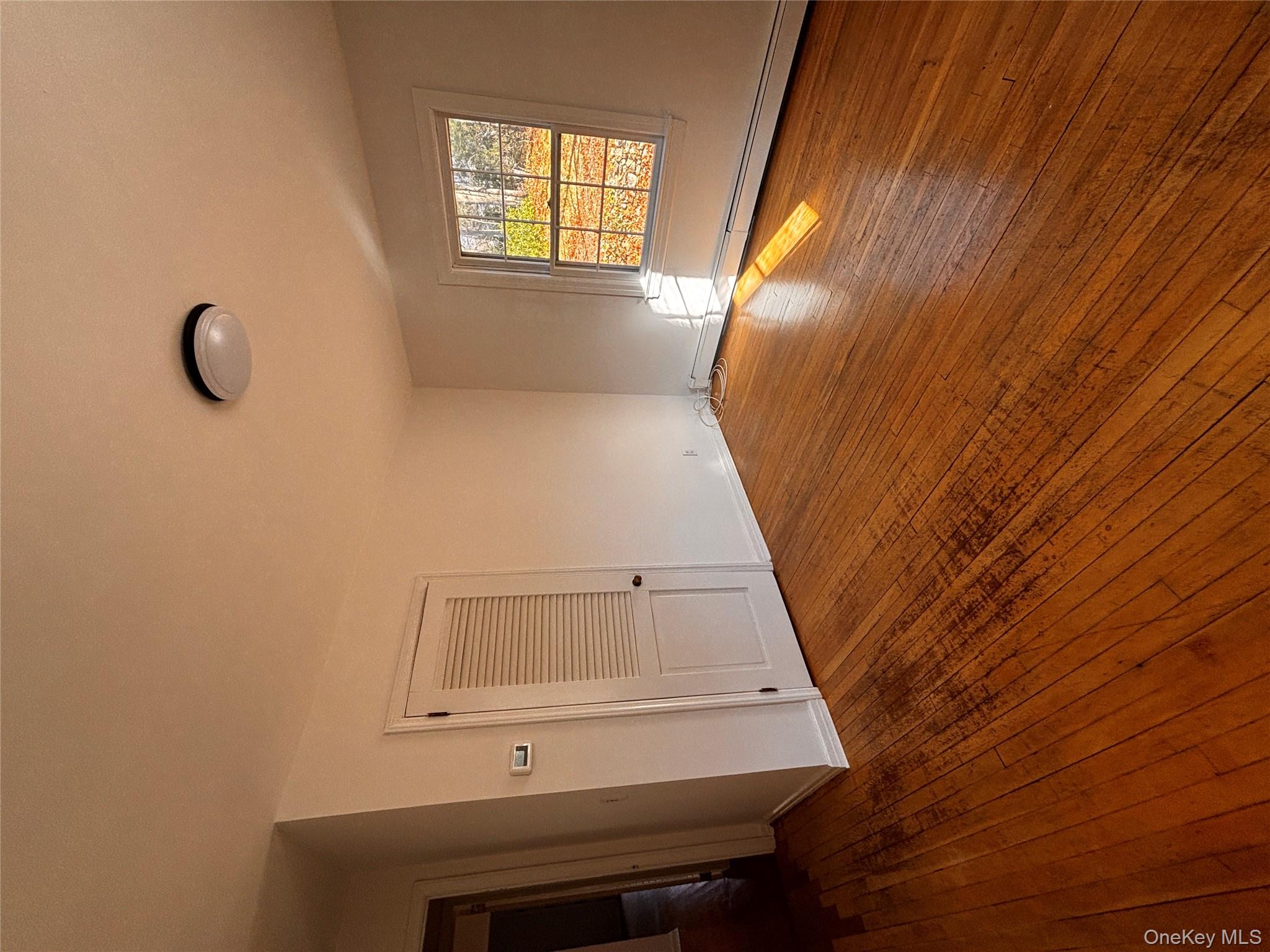 67 Turkey Lane Cold Spring Harbor, NY 11724 - Photo 10 of 18 a view of empty room with wooden floor and fan