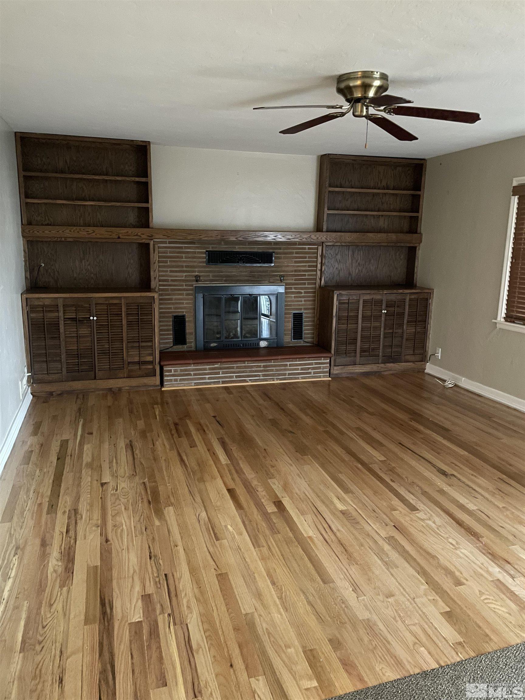 923 University Terrace Reno, NV 89503 - Photo 3 of 13 a view of a living room with wooden floor and a fireplace