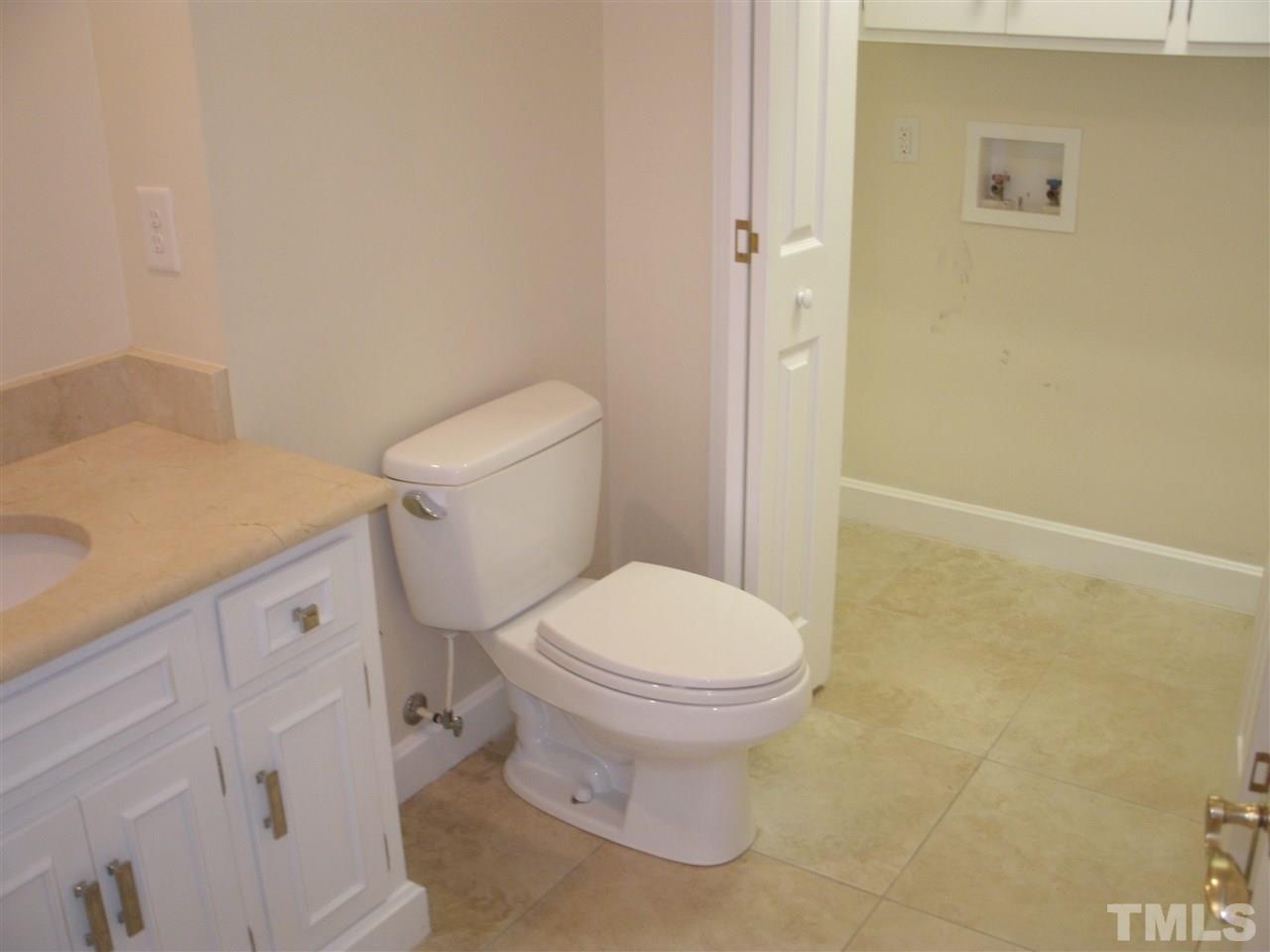 630 Tant Road Spring Hope, NC 27882 - Photo 25 of 25 Half bath with Washer/Dryer behind bi-fold doors.