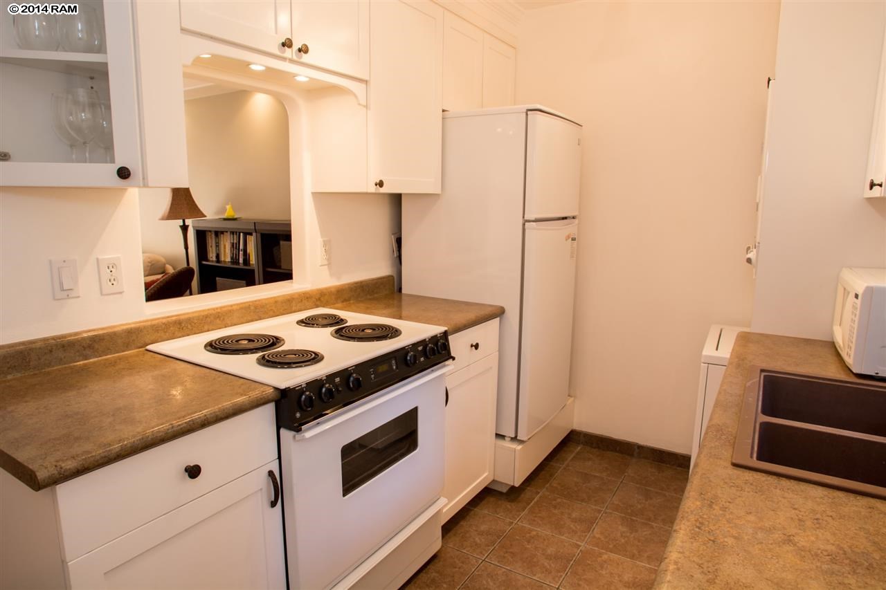 2219 South Kihei Road, Unit B214 Kihei, HI 96753 - Photo 12 of 20 a kitchen with a stove and a refrigerator