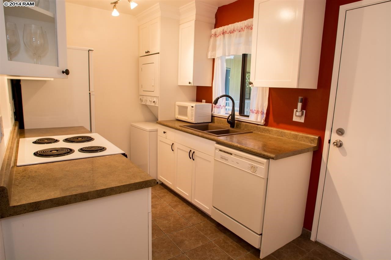 2219 South Kihei Road, Unit B214 Kihei, HI 96753 - Photo 14 of 20 a kitchen with stainless steel appliances granite countertop a sink stove and refrigerator