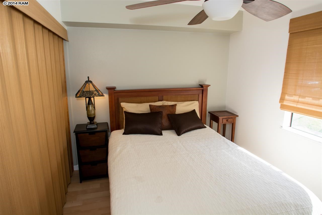2219 South Kihei Road, Unit B214 Kihei, HI 96753 - Photo 15 of 20 a bed sitting in a bedroom next to a window
