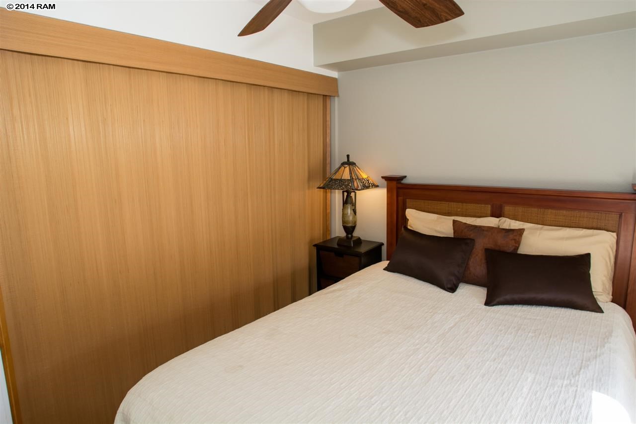 2219 South Kihei Road, Unit B214 Kihei, HI 96753 - Photo 16 of 20 a bedroom with a bed and a curtain