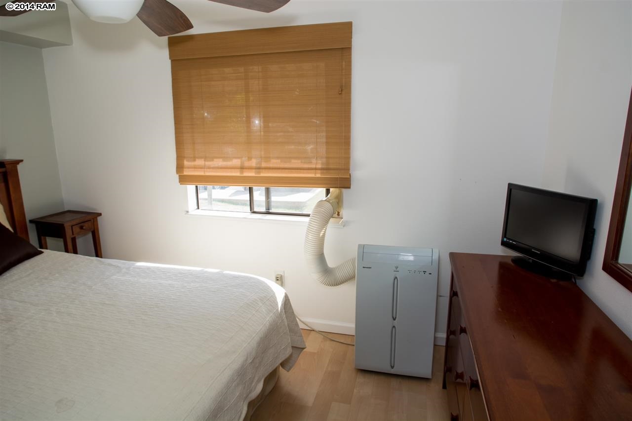 2219 South Kihei Road, Unit B214 Kihei, HI 96753 - Photo 17 of 20 a bedroom with a bed tv and a window